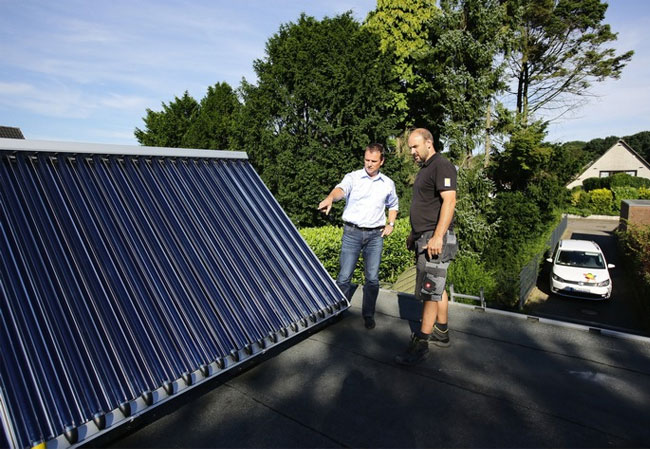 Bundesweiter Praxistest untersucht Solarthermie in 9 Haushalten / Erfahrungen von Verbrauchern online / Sonnenenergie senkt CO2-Ausstoß / Praxistester Carsten Mönkemeyer (links) während der Installation seiner Solarthermieanlage. Im neuen Online-Leitfaden "Schritt für Schritt zur Solarthermie" sind alle Erfahrungen der Praxistest-Haushalte / Pressebild