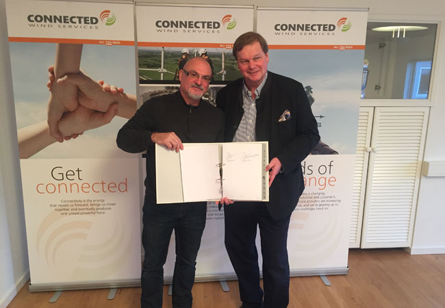 Photo: Eric Caradec, Managing director of Velocita énergies (left) and Felix Overbeck, CEO, Connected Wind Services signing the agreement which means that Connected Wind Services will act as the service provider for Envision wind farms in France.