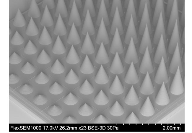 PB: An array of micro needles with an individual base diameter of 500 µm and varying heights from 260 µm to 2,000 µm was fabricated with a 10x objective using adaptive resolution. / © UpNano GmbH