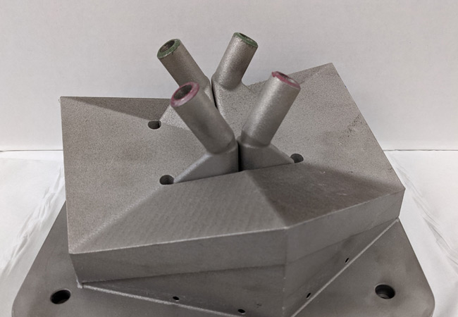 PB: 3D Heat exchanger prototype / Caption: An image of the subscale 3D printed heat exchanger prototype that was successfully tested at temperatures close to 400°F higher than conventional devices.