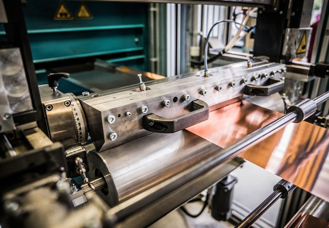 PB: Die Kupferfolie wird mit dem Slurry mithilfe einer Schlitzdüse kontinuierlich beschichtet. © Studio Wiegel / Fraunhofer-Institut für Produktionstechnologie IPT