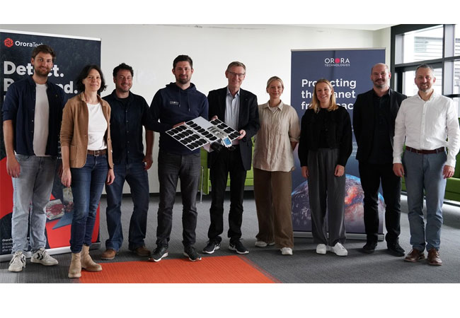 PB: Lizenzvereinbarung DLR und OroraTech - Das DLR-Earth Observation Center (EOC) und die Firma OroraTech kooperieren seit Jahren auf dem Gebiet der automatisierten Feuererkennung und -klassifikation. Beim gemeinsamen Gruppenbild halten Dr. Martin Langer (Mitte links), CEO OroraTech, und Prof. Stefan Dech (Mitte rechts), Direktor des Deutschen Fernerkundungsdatenzentrums des DLR, das Modell eines Erdbeobachtungssatelliten zur Detektion von Brandflächen. / ©: DLR