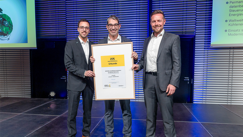 PB: Feierliche Preisverleihung: Dr. Waldemar Wagner (rechts), Produktmanager NEXAIRA und Pascal Schöpf (links), Technologie- und Innovationskommunikation nehmen die Auszeichnung von Umweltstaatssekretär Dr. Andre Baumann (mittig) entgegen. – Credit: bmf Armin Burkhardt